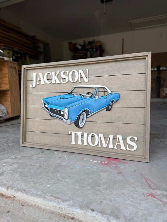 Jackson Thomas wood sign with blue car