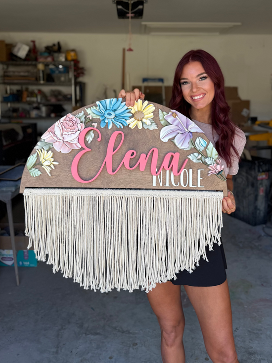 Elena Nicole on a half circle with flowers and fringe hanging