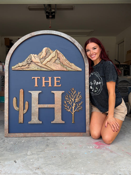 The H logo Arch sign with blue background and copper accents