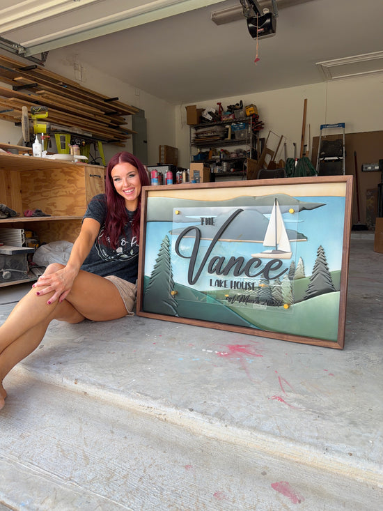 Vance lake house sign with sailboat and trees