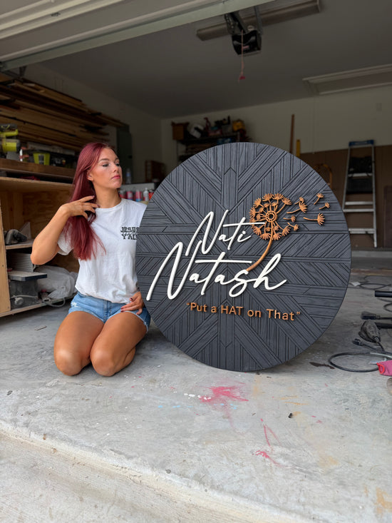 Nati Natash put a hat on that logo with flower and black patterned wood background