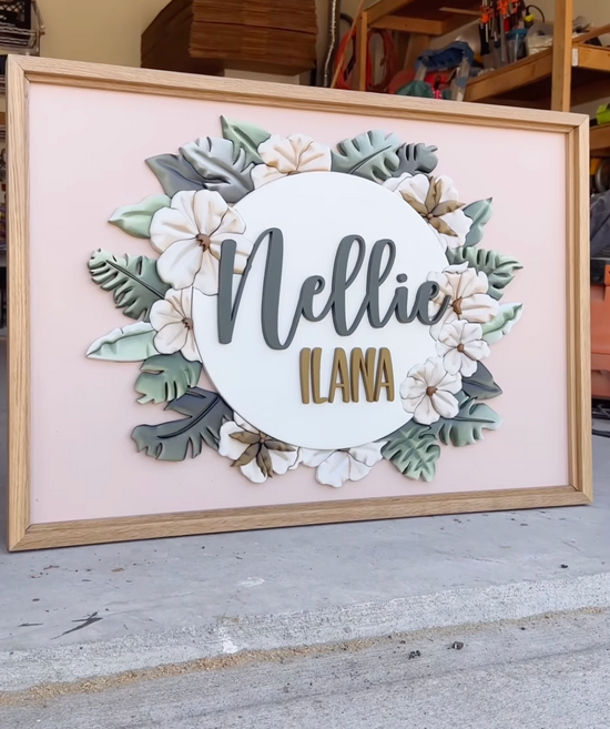 Nellie Ilana name on wood sign with pink background and tropical flowers