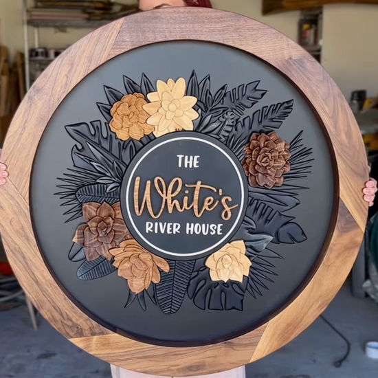 The Whites River House round sign with walnut frame and wooden florals